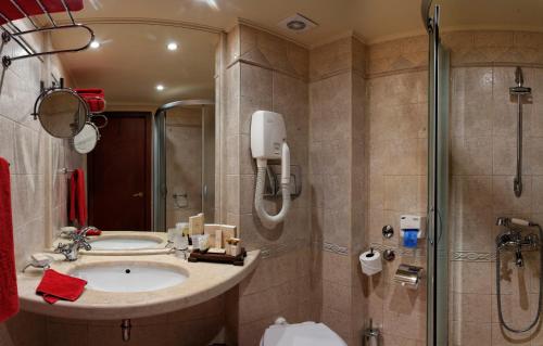a bathroom with a sink and a shower at Capitol Hotel in Varna City