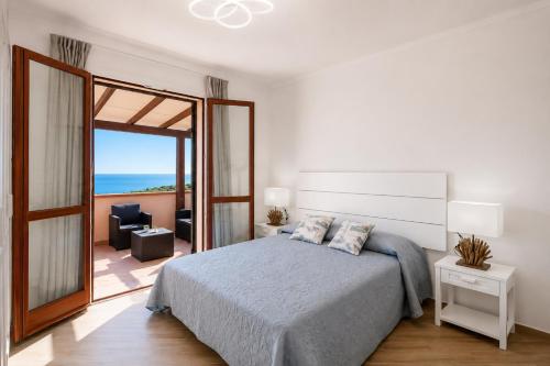 a bedroom with a bed and a view of the ocean at Casa Andreale in Capoliveri