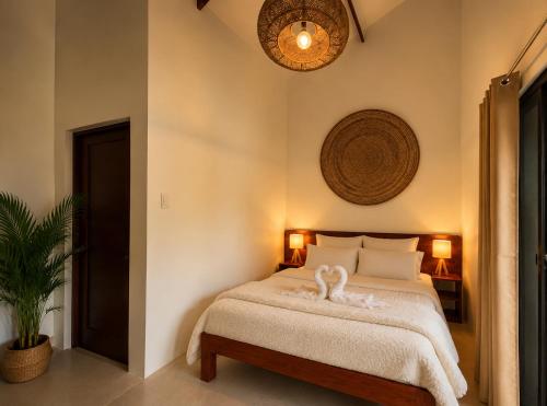 a bedroom with a bed with a swan on it at Anaiah Garden Resort in Moalboal