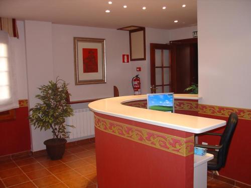 a kitchen with a large island in a room at Hospederia el Fielato in El Burgo de Osma