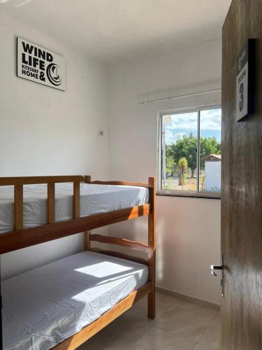 a room with two bunk beds and a window at Wind Life Home in Itarema