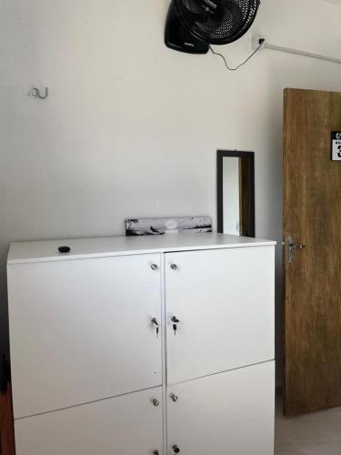 a white cabinet in a room next to a door at Wind Life Home in Itarema