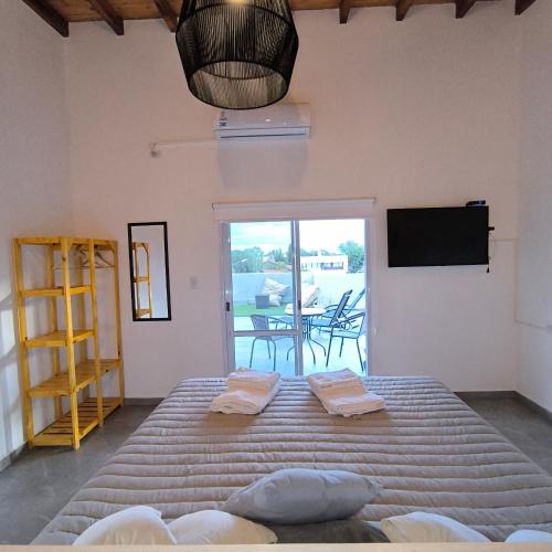 a bedroom with a large bed and a television at TERRAZA TERRAZA Merlo Apartments in Merlo