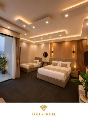 a hotel room with two beds and a window at Lotus Apartments l New Cairo in Cairo