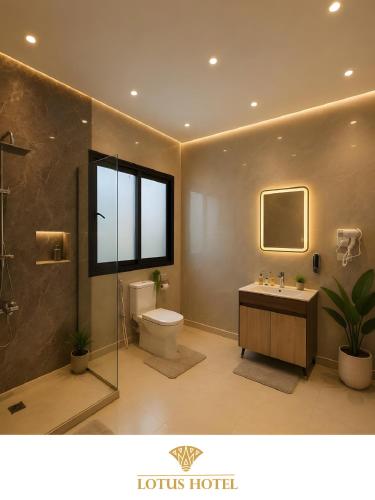 a bathroom with a toilet and a sink and a window at Lotus Apartments l New Cairo in Cairo