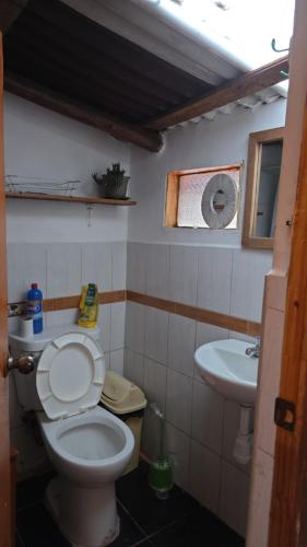 a bathroom with a toilet and a sink at Pisac cosmic in Pisac