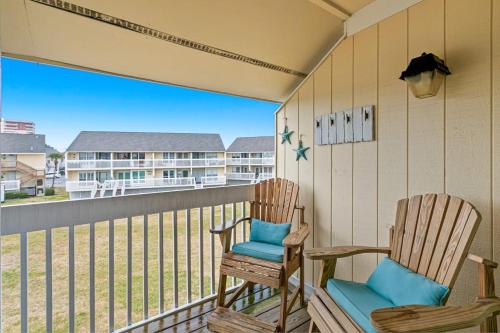 two chairs sitting on the balcony of a condo at Coastal Condo with heated pool hot tub tennis & beach access in Destin