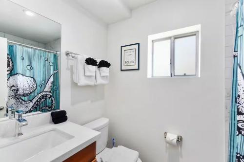 a bathroom with a sink and a toilet and a window at DTPH Cozy Corner - Pool & Parking in Phoenix