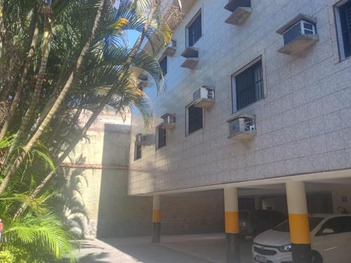 a building with a car parked in front of it at Hotel Obsession in Pôrto Esperidião