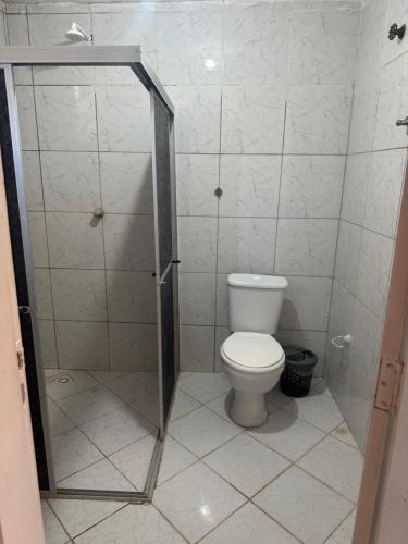 a bathroom with a toilet and a shower stall at Casa Harmonia in Trairi