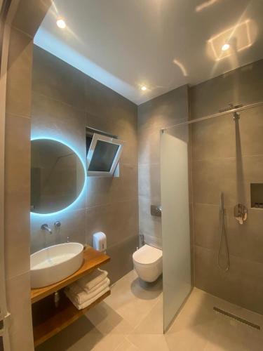 a bathroom with a sink and a toilet and a shower at Villa Xani in Himare