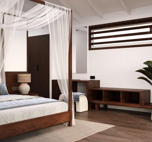 a bedroom with a canopy bed and a desk at Iririki Island Resort & Spa in Port Vila