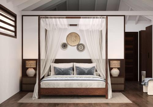 a bedroom with a canopy bed with blue pillows at Iririki Island Resort & Spa in Port Vila