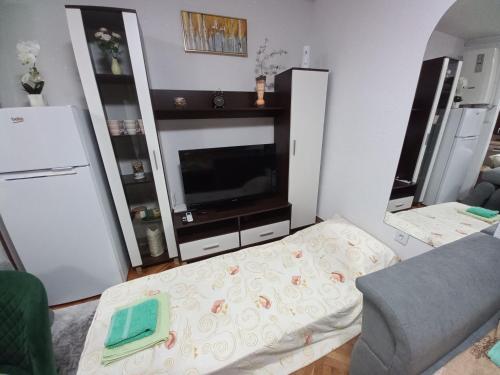 a living room with a flat screen tv and a couch at Apartment Meri with garage in Velika Kladuša