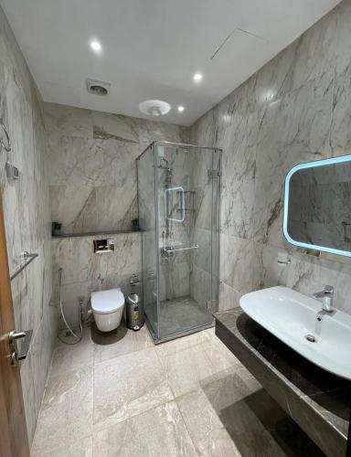 a bathroom with a shower and a sink and a toilet at The Gate 05 New Alamein in El Alamein