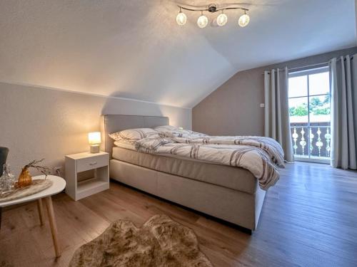a bedroom with a large bed and a window at Bayerischer Wald in Waldkirchen