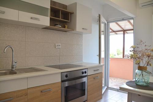 a kitchen with a sink and a stove at Apartments and rooms by the sea Nevidjane, Pasman - 11902 in Neviđane