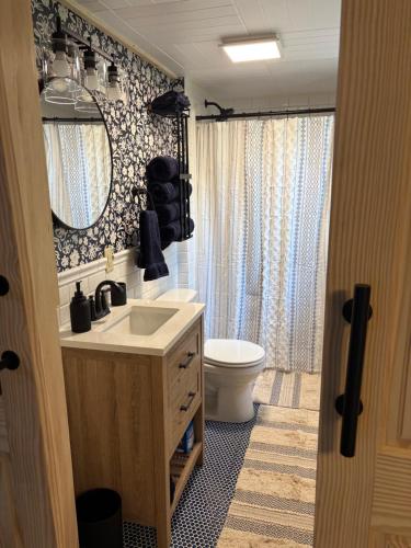 a bathroom with a sink and a toilet and a mirror at The Perfect Match River Retreat in Buffalo City