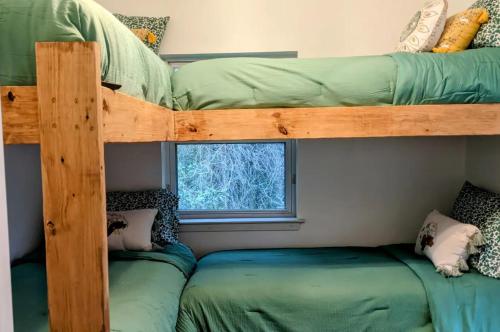 two bunk beds in a room with a window at Private Beach, secluded! in Covington
