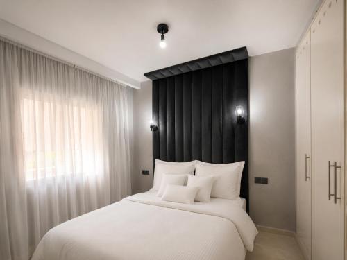 a bedroom with a large white bed with white pillows at Nour House Imi Ouaddar in Agadir nʼ Aït Sa