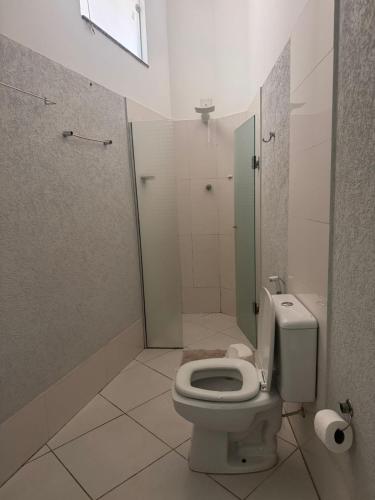 a bathroom with a toilet and a shower at Iter Hotel in Rifaina