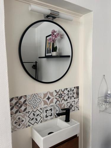 a bathroom with a mirror and a sink at Studio 156 in Boussu