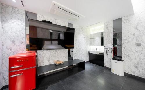 a kitchen with a red refrigerator in a room at Yeoksam Lumiere Hotel in Seoul