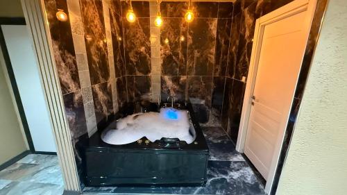 a bathroom with a bath tub with snow on the floor at Viyana Suite Hotel in Istanbul