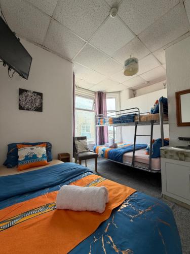 two beds in a room with two bunk beds at Suncrest Hotel # Self-check-in in Blackpool