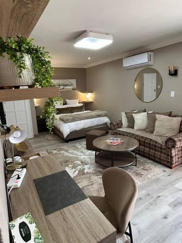 a living room with a couch and a table at Executive en-Suite, cozy, comfy and spacious in Baragwanath