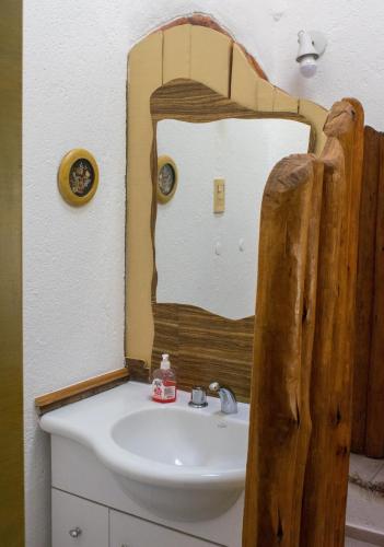 a bathroom with a sink and a mirror at Casa Armonía in Villa Las Rosas