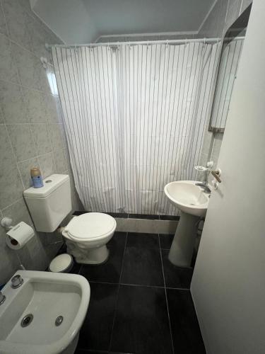 a small bathroom with a toilet and a sink at Casa a pie de playa in Mar de Cobo