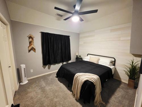 a bedroom with a bed and a ceiling fan at North Shore Lake Community in The Colony