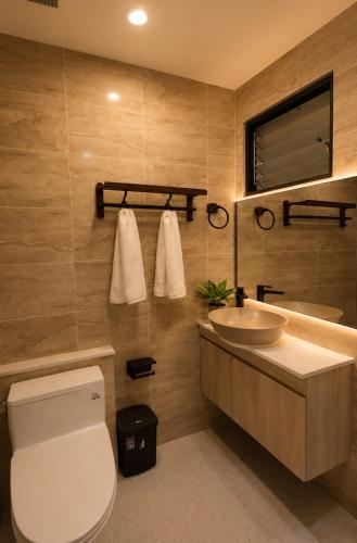 a bathroom with a white toilet and a sink at Punnawithi House Bangkok in Amphoe Phra Khanong