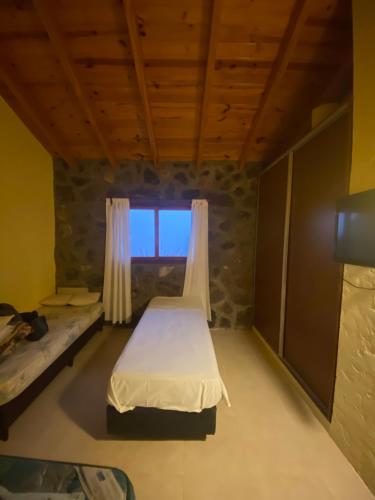 a small room with a bed and a window at Huellas de Berna in Villa Berna