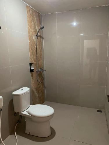 a bathroom with a toilet and a shower at Katra Sembalun in Sembalun Lawang