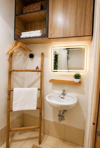 a small bathroom with a sink and a ladder at The Narci Suites in Manila