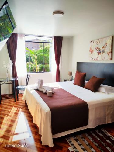 a bedroom with a bed with a teddy bear on it at Casa Baraquel in Arequipa