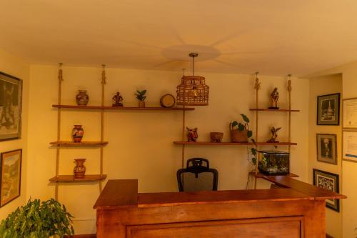 a room with a desk and shelves on the wall at Casa Úrsula in Panama City