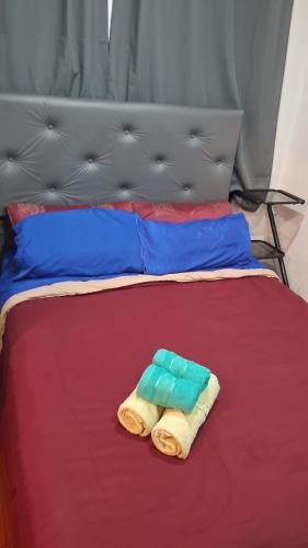 two towels sitting on top of a bed at CHE LOLITA HOUSE 2 in Buenos Aires