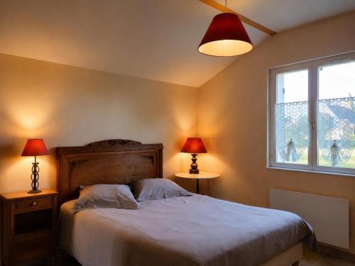 a bedroom with a bed and two lamps and a window at Maison 2 chambres avec jardin clos en Sologne, animaux acceptés - FR-1-489-258 in Aurouer