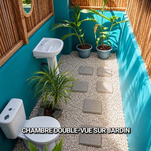 a bathroom with a sink and a toilet and plants at Casa Lantana in Antsiranana