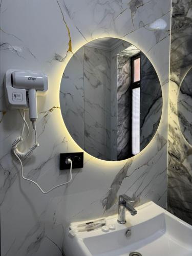 a bathroom with a sink and a mirror at Zere Motel in Türkistan
