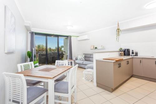 a kitchen and living room with a table and chairs at Sea Air 6 in Yeppoon