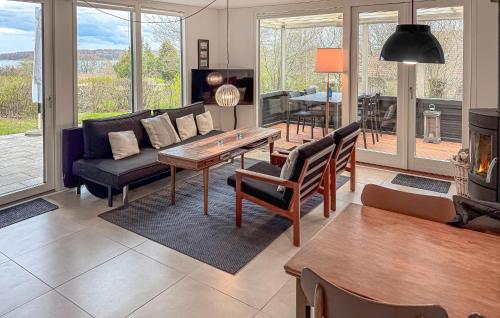 a living room with a couch and a table at Gorgeous Home In Rødekro With Wifi in Rødekro