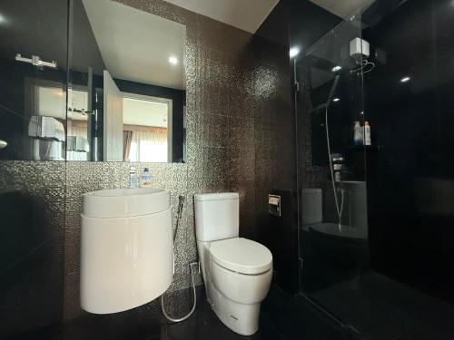 a bathroom with a toilet and a sink at BTS Thong Lor Central High -rise Condo in Bangkok