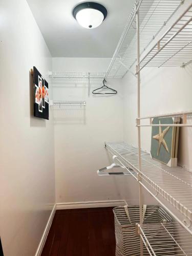 a walk in closet with a white wall at Private MasterBedroom in Charlottetown