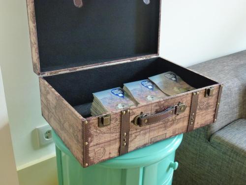 an old trunk sitting on top of a bucket at Canvas Atelier Hostel in Porto
