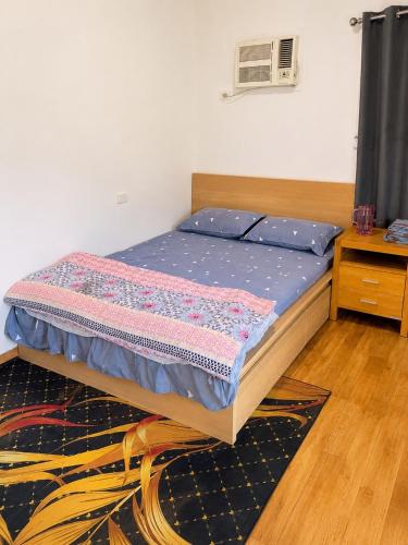 a bedroom with a bed with blue sheets and a table at Private Guest Studio House, Separate Entry in Brisbane