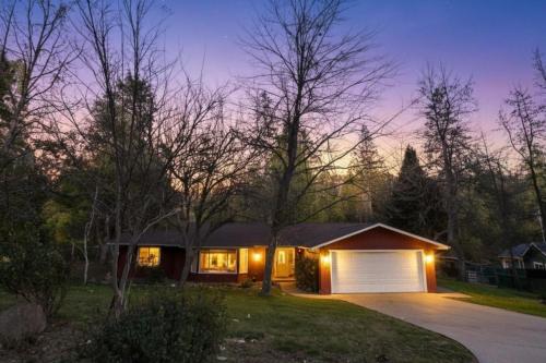 a house with a garage at night at Mountain House in Mariposa